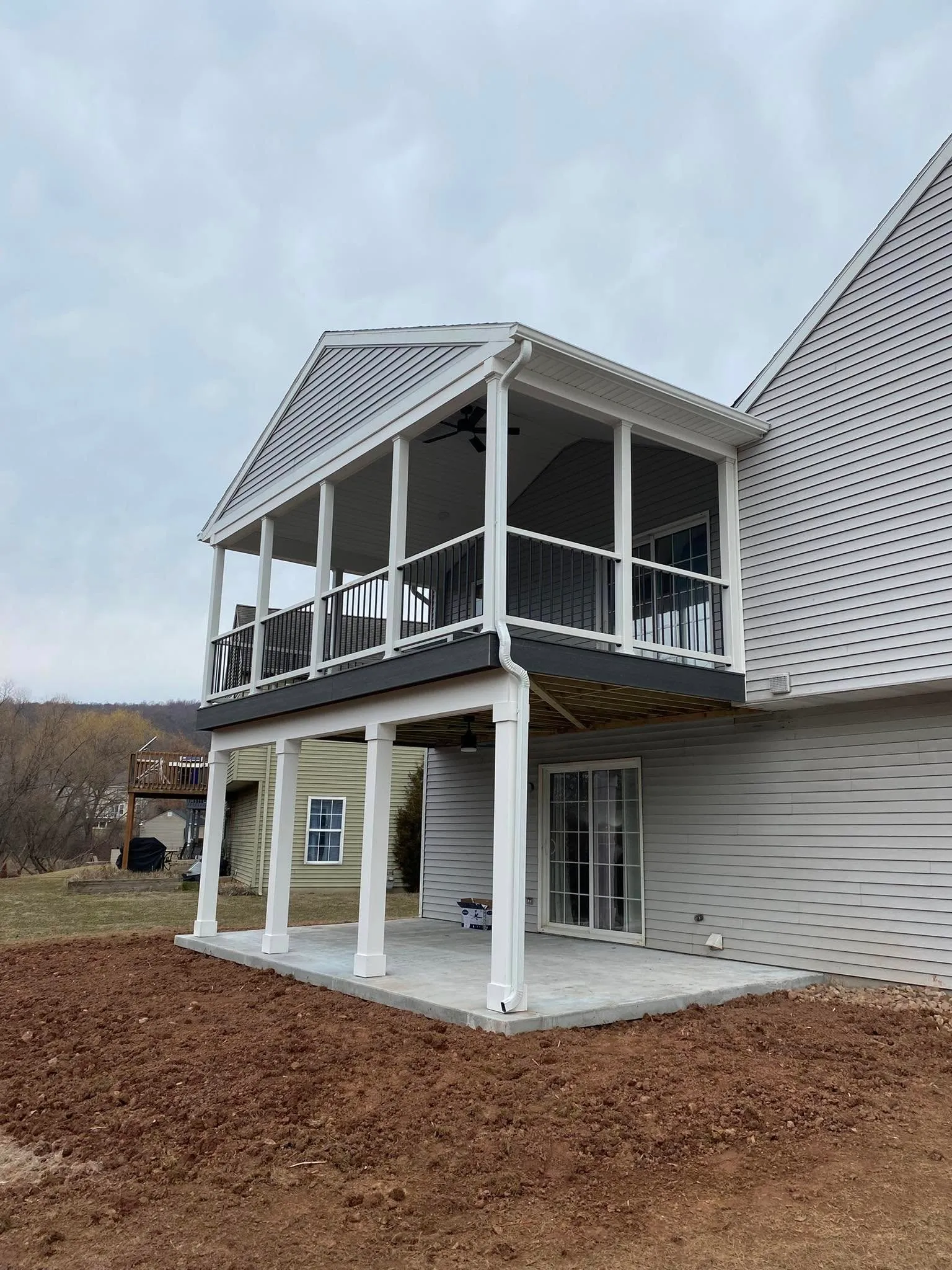 Covered porch addition — Two-story porch + columns + skirt